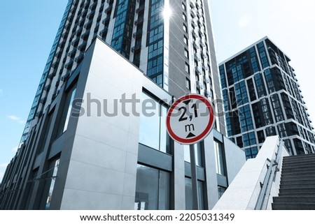 Traffic sign Height limit near modern building, low angle view