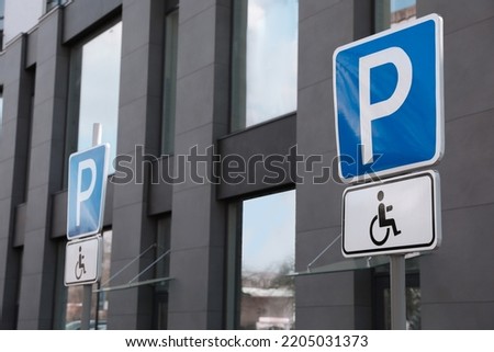 Traffic sign Parking for people with disability near modern building