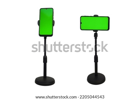 black cellphone tripod mount. with a green screen phone. isolated white background Royalty-Free Stock Photo #2205044543