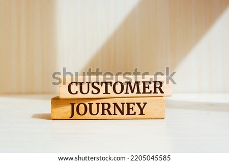 Wooden blocks with words 'Customer journey'.