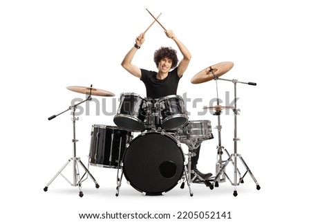Young male drummer holding drumsticks up isolated on white background Royalty-Free Stock Photo #2205052141