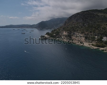 Aerial view of Plage Mala beach in Cap d'Ail, French Riviera near MonteCarlo and Monaco. Drone view of the Bay of Mala with its famous beaches in Monaco, Cap d'Ail famous spot with yachts and luxury.