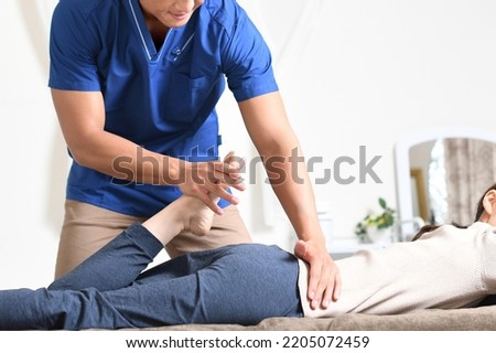Male chiropractor and female patient who perform chiropractic massage Royalty-Free Stock Photo #2205072459