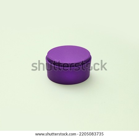 Purple closed ellipse box for molding  handmade solid shampoo and soap on green background Royalty-Free Stock Photo #2205083735