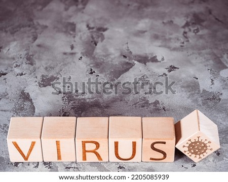 Pandemic or epidemic as a concept of disease spread as VIRUS text on wooden cubes