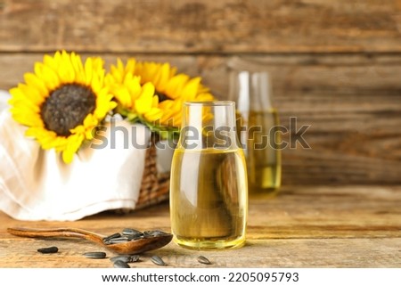 Bottle with sunflower oil on wooden table