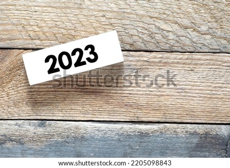 2023 on a wooden block and a table               