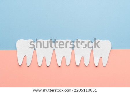 Healthy white tooth cartoon made from paper. Dental care concept.