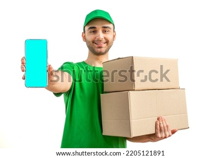 Delivery man with a box, smartphone. Courier in uniform cap and t-shirt service fast delivering orders. Young guy holding a cardboard package. Character on isolated white background for mockup design