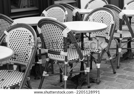 Paris, France. Outdoor Cafe, Restaurant Terrace Tables with Wicker Chairs. Classic French Cafe View.