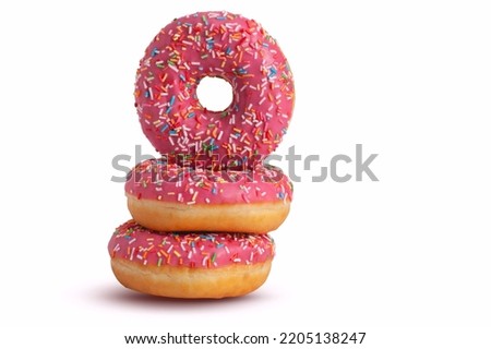 Stack of glazed donuts with pink icing. Isolated on white background. Copy space