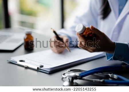 Doctor are recommending medicines to patients after being examined and diagnosed by the patient's doctor, the concept of treatment and symptomatic medication dispensing by the pharmacist. Royalty-Free Stock Photo #2205143255