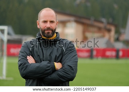 Portrait of a male football coach at the stadium field.  Royalty-Free Stock Photo #2205149037