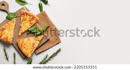 Composition with slices of tasty pizza and herbs on light background with space for text, top view