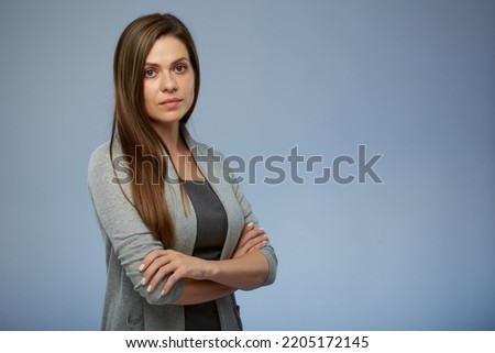 Serious business woman in office clothes standing with arms crossed. Isolated female portrait.
