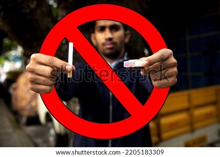 Man hands holding cigarette and matchstick for quit smoking.  Health concept. No smoking sign. Red prohibition with cigarette and matchstick. Main focus on breaking cigarette ,  blur background. 