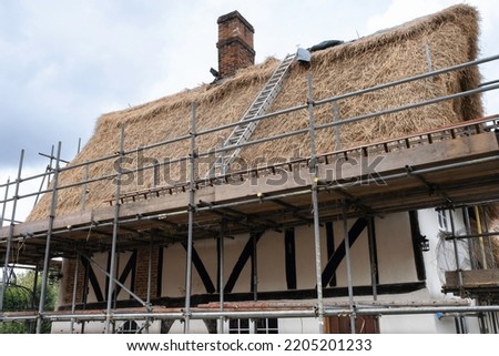 A cottage gets a thatched roof in Kersey, Suffolk, UK Royalty-Free Stock Photo #2205201233