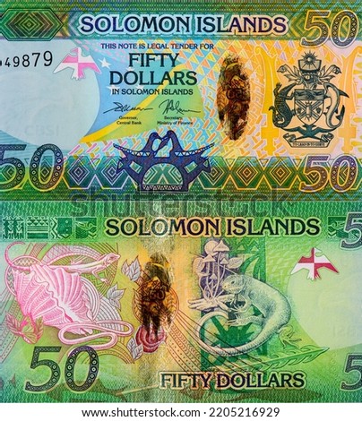 Coat of Arms depicting a crocodile and a shark. Ceremonial paddle. Bonito hook. Portrait from Solomon Islands 50 Dollars 2013 Banknotes. 