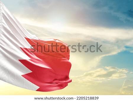Bahrain national flag waving in beautiful sky.