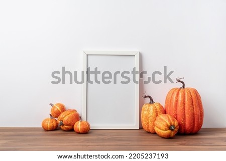 Photo frame and white pumpkins. Mockup Copy space for artwork. Autumn decor in interior.