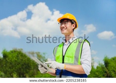 Portrait of an Asian engineer at a construction site working during a project review.