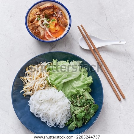Chicken Bun Cha with noodle, roll and salad served in a dish isolated on grey background side view of vietnam food