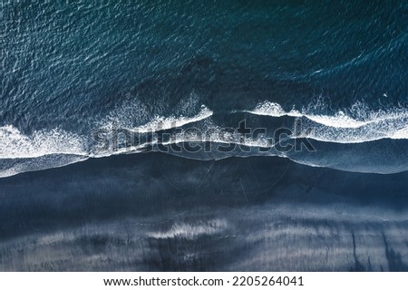 Aerial drone view of moody atlantic ocean wave on black sand beach in summer at Iceland Royalty-Free Stock Photo #2205264041