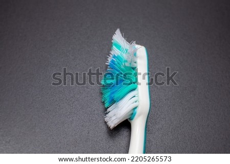 used toothbrush isolated on dark background Royalty-Free Stock Photo #2205265573