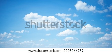 cartoon clouds running and having fun in the blue sky.panorama view.