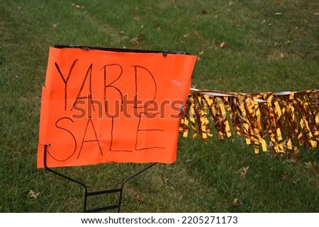 Yard sale sign in a yard