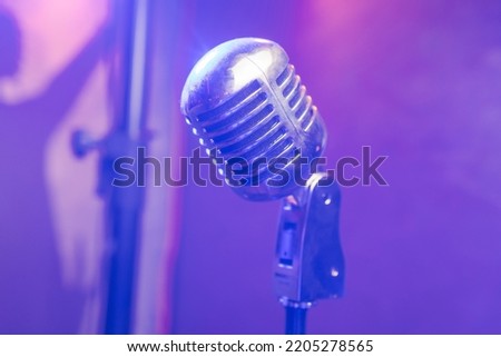 Retro microphone on stage in a pub or American Bar restaurant during a night show.