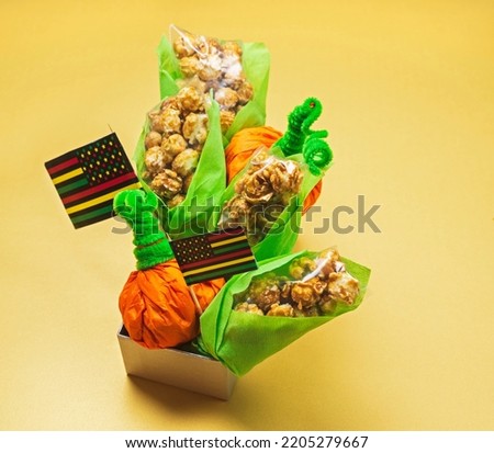 treats for kids packaged in the shape of pumpkin and corn on the cob for Halloween or Kwanzaa