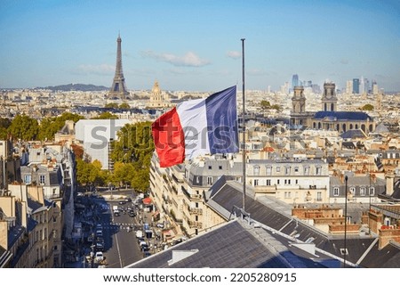 Scenic Parisian cityscape. Aerial view of the Eiffel tower over the French flag in Paris, France Royalty-Free Stock Photo #2205280915