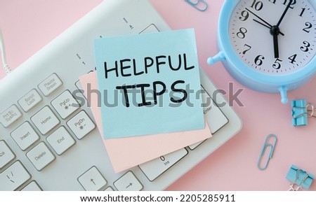 Helpful tips text write on paper on keyboard as background
