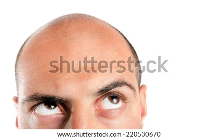 Bald guy looking up , thinking. Lots of copy space. Royalty-Free Stock Photo #220530670