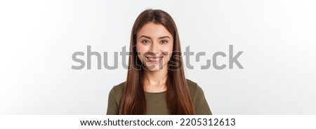 Close-up portrait of yong woman casual portrait in positive view, big smile, beautiful model posing in studio over white background. Royalty-Free Stock Photo #2205312613