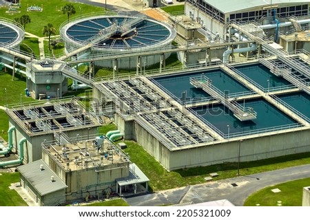 Aerial view of modern water cleaning facility at urban wastewater treatment plant. Purification process of removing undesirable chemicals, suspended solids and gases from contaminated liquid Royalty-Free Stock Photo #2205321009