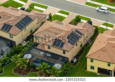 Aerial view of expensive modern houses with outside swimming pools covered with mosquito mesh on metal frame for insect protection in Florida closed living club Royalty-Free Stock Photo #2205321021