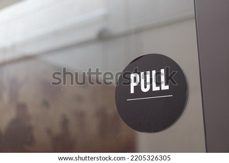 Pull sign on glass door. pull the door. 