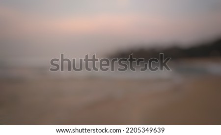 Defocused abstract background of beautiful view of beach and sea in the evening with natural light. Abstract blurred background.