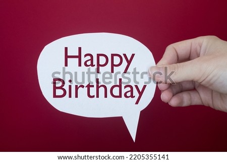 Speech bubble in front of colored background with Happy Birthday text.