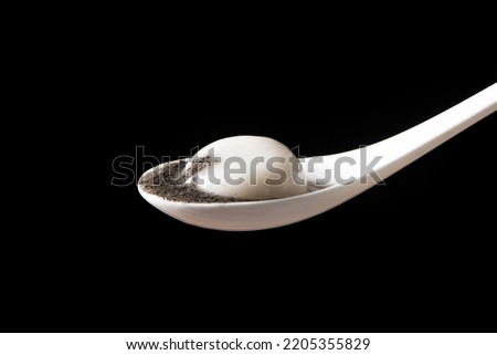 glue pudding or tangyuan with black sesame on black background Royalty-Free Stock Photo #2205355829