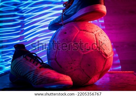 Soccer still life, with tennis and soccer ball with red and blue colors.slow shutter speed.