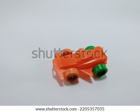 toy car, orange color vehicle on white background.