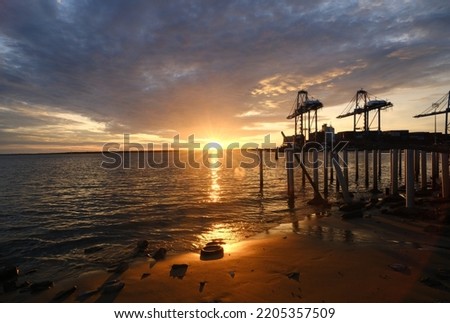 A picture of sunray at the ocean with silhouette crane and beautiful cloud insight.