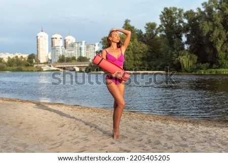 Tanned woman in the city on the coast