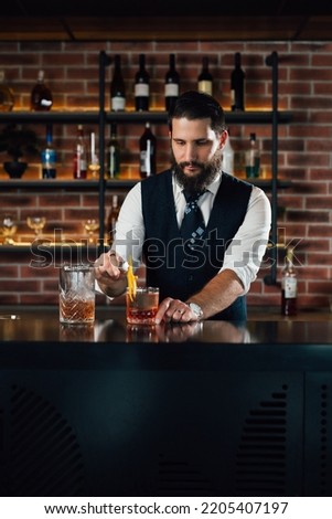 barman decorate negro martini cocktail Royalty-Free Stock Photo #2205407197