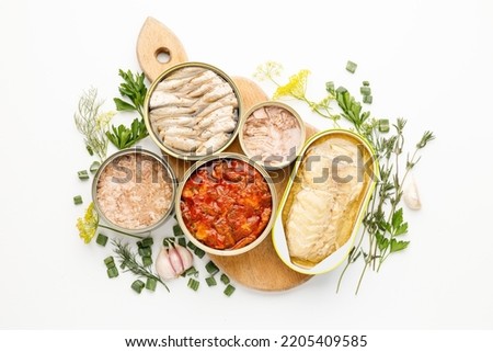 Processed fish in tins, canned seafood on a white background. Royalty-Free Stock Photo #2205409585