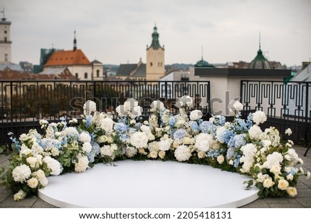 Arch for outdoor wedding ceremony with flowers. Royalty-Free Stock Photo #2205418131