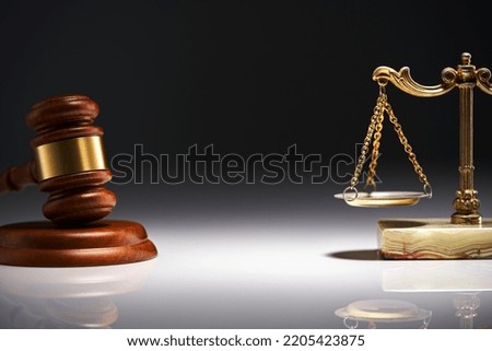 gavel hammer and libra scale against gray background